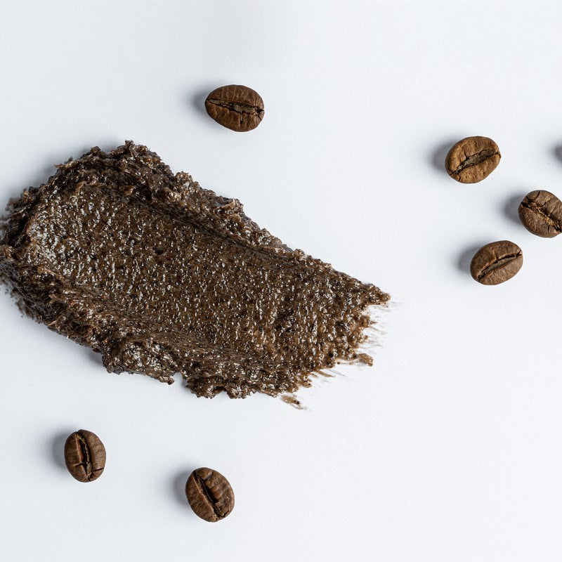A coffee cream swatch with roasted coffee beans on a white background